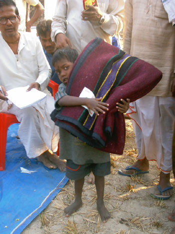 boy securing a blanket at such a camp for winter